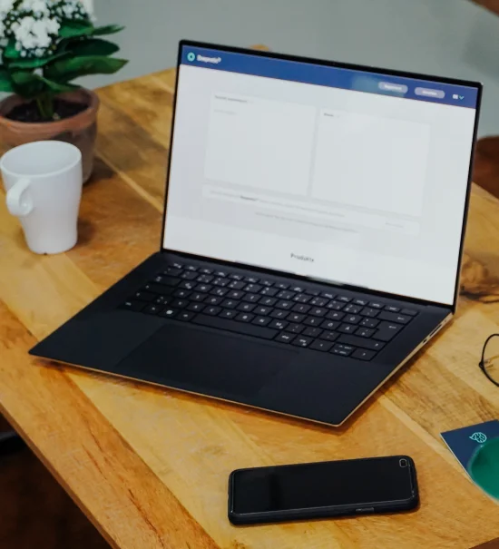 A laptop on a modern desk with Deepnetic Social open.