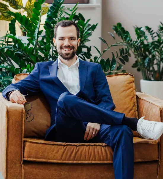 Daniel Vogel, founder and CEO of Deepnetic, smiling in an office.